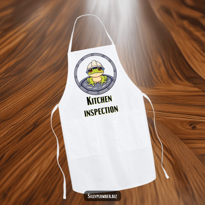 Funny Apron of a frog wearing a hard hat, peeking from a manhole cover, for kitchen work.