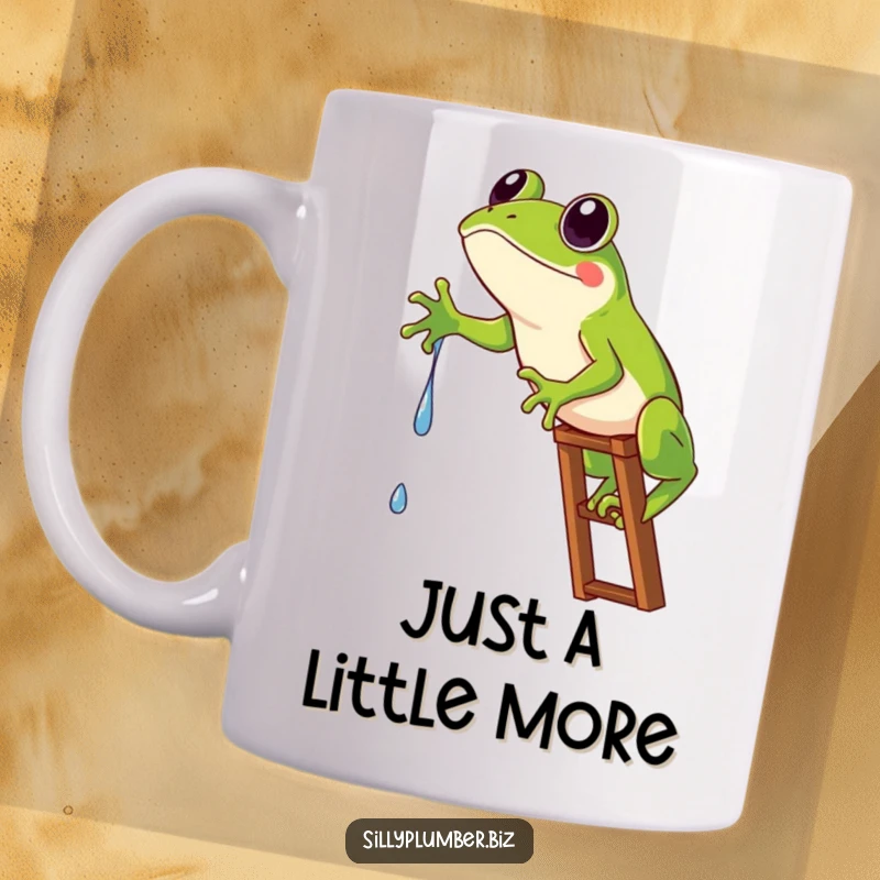 Funny Mug showing a frog comically stuck on a ladder, desperately reaching for a single water drip.