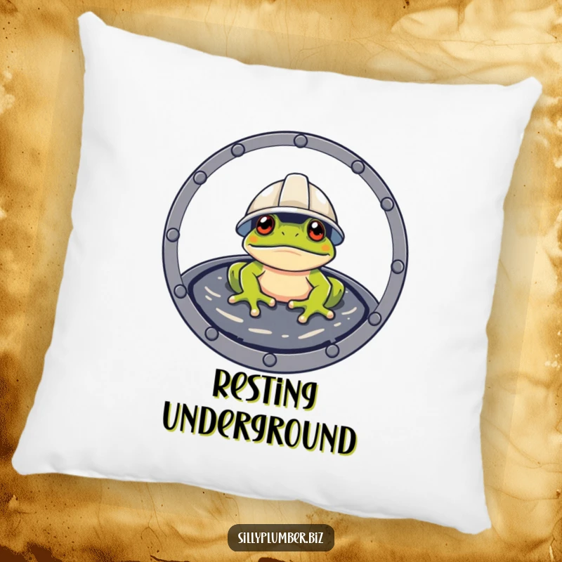 Funny Pillow with a frog wearing a hard hat, peeking from a manhole cover, for humorous decor.
