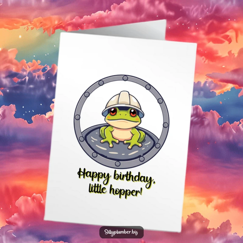 Funny Free Printable Birthday Card with a frog wearing a hard hat, peeking out from a manhole cover, ready for some action.